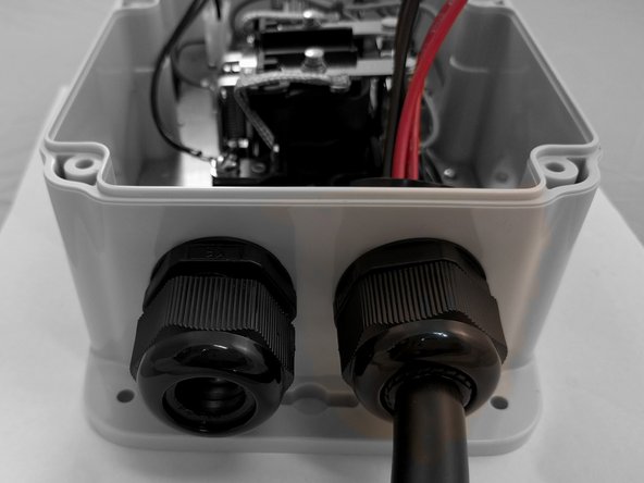 Insert EV Cable through the Cable Gland on the right and tighten.