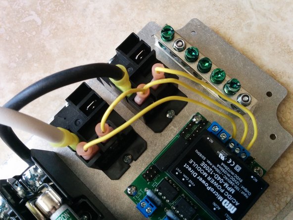 Screw the 22AWG wires to the AC line block on the OpenEVSE board.