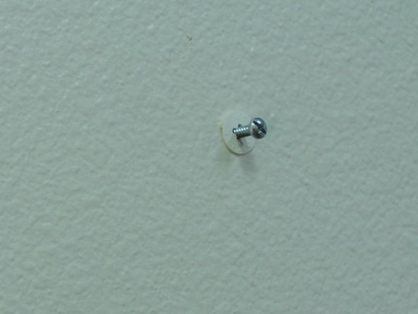 Insert the drywall anchor and screw in until flush with the wall