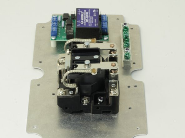 Mount hex standoffs to the top side of the plate mounting plate with 4 - 6 mm M2.5 screws. Mount the OpenEVSE board to the hex standoffs with the other 4 - 6mm M2.5 screws.