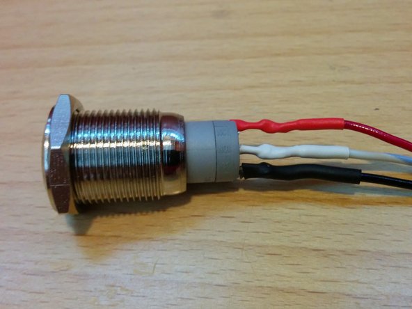 Solder the red wire to the positive terminal at the end of the row labeled &quot;+&quot; and shrink the tubing over the connections on all three wires.