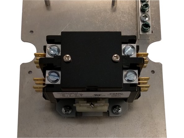 Position the plate with the 4 holes for the OpenEVSE controller up top and the Earth Ground bus bar on the right.