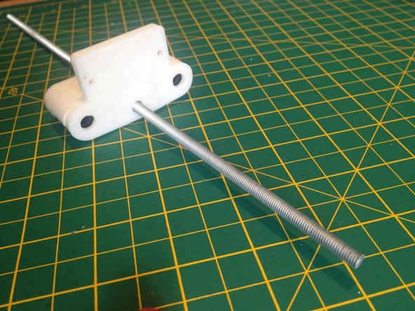 Insert and screw the threaded rod through the trapped M5 nut.