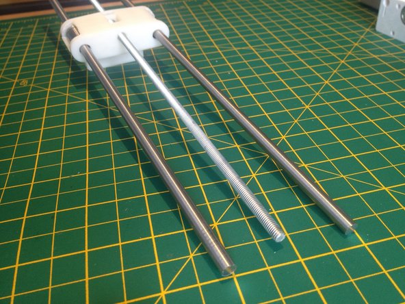 Slide the two smooth rods through the LM6UU linear bearings.