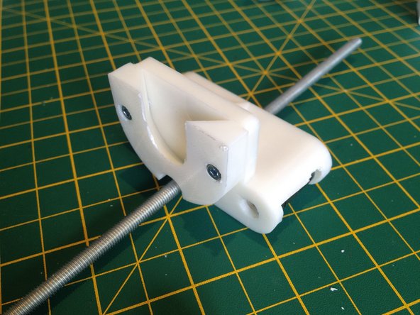 Use two M3 10mm bolts and nuts to attach the syringe plunger retainer to the syringe carriage.