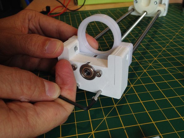 Insert four M3 nuts into the syringe clamp.