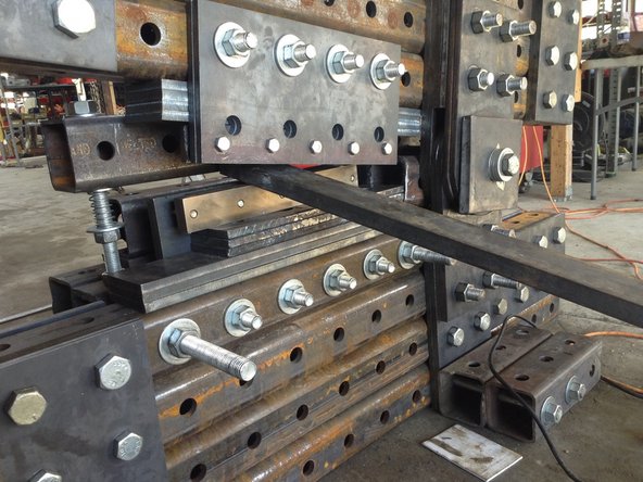 Place a spacer between the top blade and the bottom blade so that the spacer presses down on the blade to tension it into position.