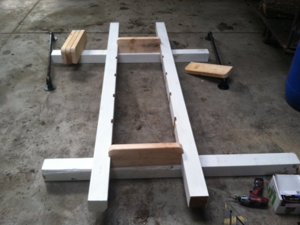 Slide one step into the top and one step into the bottom of the side supports.