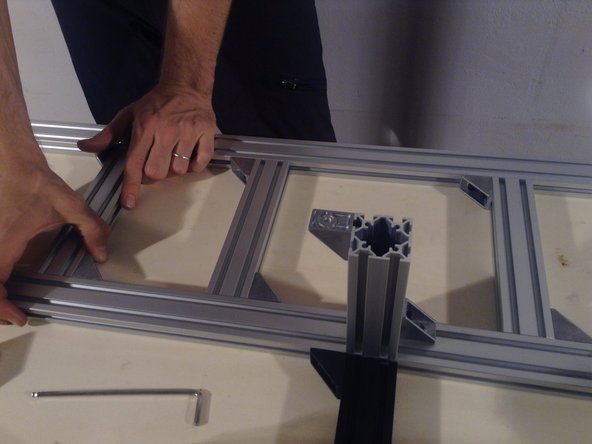 Install 3 short 2040 extrusions on the rear base of the frame.