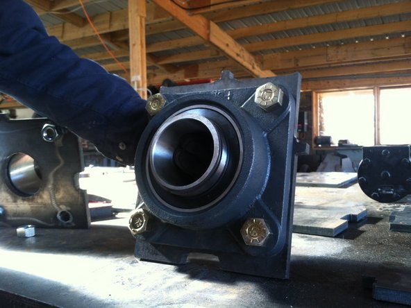 Attach bearing to "large bearing plate" (insert part number). This bearing faces inside the mount - towards the other bearing.