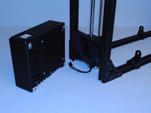 Using 4x M5 x 8 BHCS, M5 Washers and M5 T-nuts, attach the Electronics case assembly to the frame.