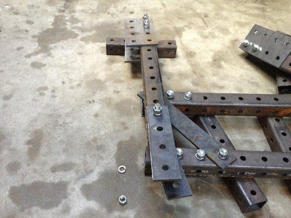 Install the Leg Pivot Plate (4x1 hole plate at bottom of photo), only on the upper hole with 7 inch bolt.