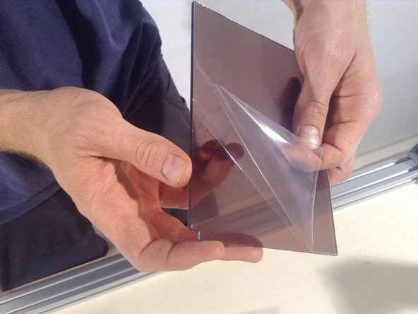 Peel the protective covering from the long panel, and insert.