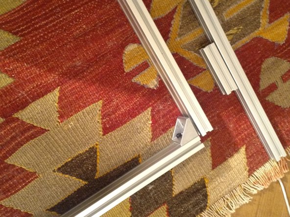 Begin assembling the door frame with corner brackets.