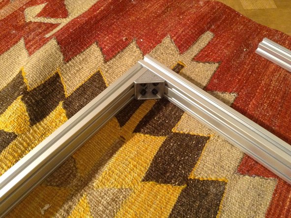 Begin assembling the door frame with corner brackets.