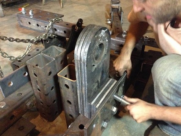 Attach 4 pivot plates and five 1x2 hole plates as spacers between Reinforcement plate and pivot tubes. Use ~6&quot; bolts