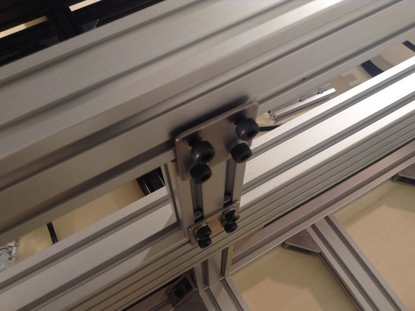 Mount 4040 extrusion for the rear of the cutting chamber - using 2 double brackets at the sides and a double planar bracket in the middle.