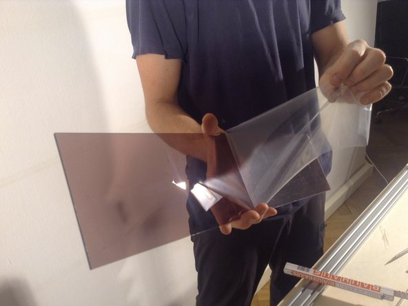 Peel the protective covering from the long panel, and insert.