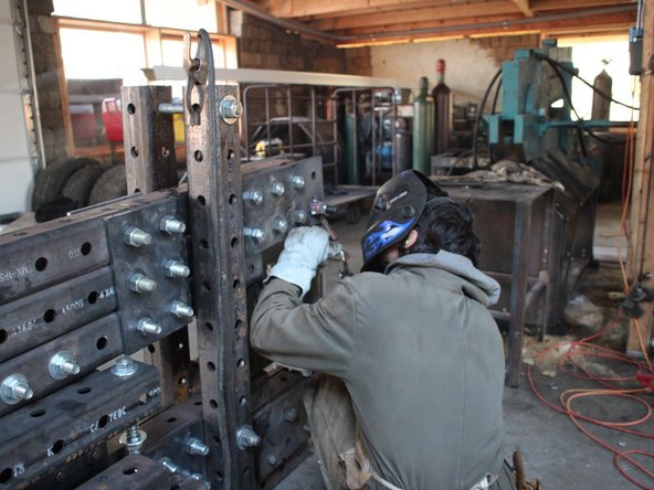 Weld each of the 4 drilled out nuts to the pivot plates.