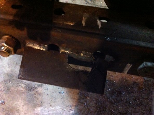Determine the location of the latch hole for the bottom quick attach part and torch it out