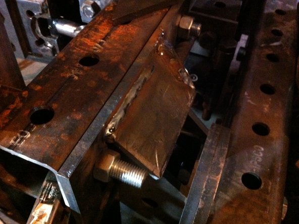 Move tractor to the backhoe and put the upper quick attach finger weldment into place on both the right and left-hand sides Of the quick attach and tack into place