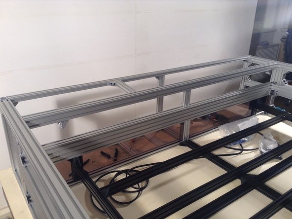 Mount 4040 extrusion for the rear of the cutting chamber - using 2 double brackets at the sides and a double planar bracket in the middle.