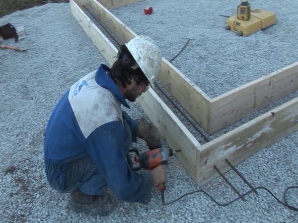 Place rebar into foundation formwork. Leave the rebar sticking out through the holes you made so that you can add on to your Microhouse in the future.