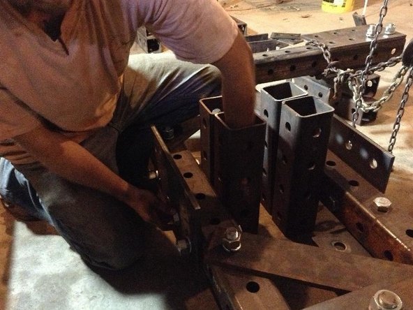 Insert bolts through the tube (bolts should not pass through the 4&quot; space between the Main Pivot Tubes because the pivot cylinders will move through this space).