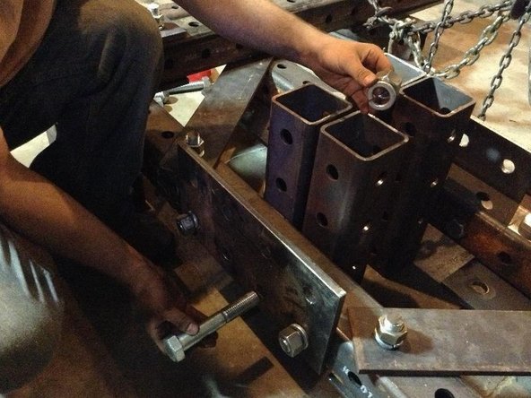 Insert bolts through the tube (bolts should not pass through the 4&quot; space between the Main Pivot Tubes because the pivot cylinders will move through this space).