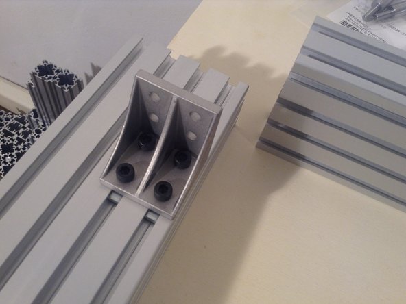 Mount the first bracket on a corner. Put the short side of the bracket on the short frame side, and the long side of the bracket on the long side. Do not tighten yet.