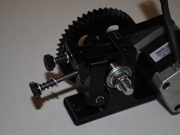 Install M4 x 55 with thumb knob, M4 washer, extruder spring, M4 washer and Extruder latch into M4 nut installed in body.