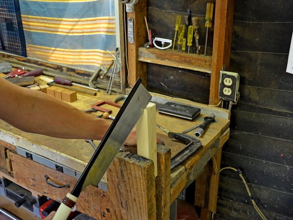 Gently pull the saw down and towards you.