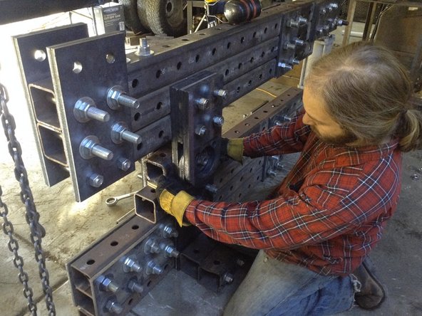 Put the cubes in between the pivot plates on either side of the shaft. Rest them on little pieces of wood temporarily so that they're bout 1/2&quot; above the tube below them.