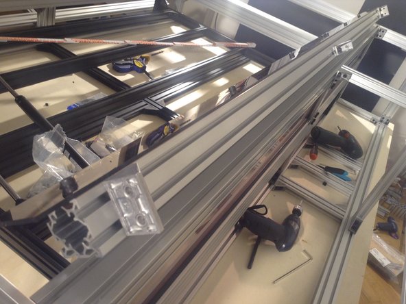 Mount 3 door mounts to the 4040 hinged extrusion. Use double brackets on the ends and a single bracket in the middle.