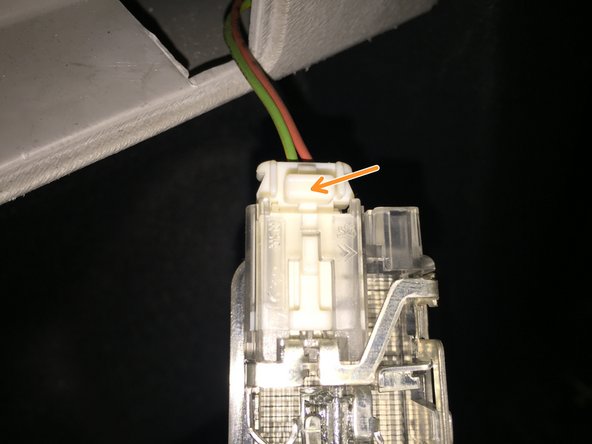 
To remove the electrical connector, press the white tab and pull.

