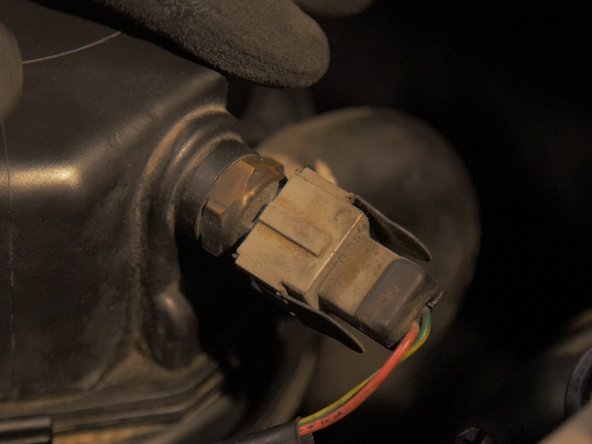 
Reconnect the air temperature sensor connector to the air box cover
