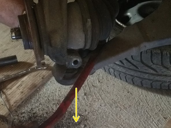 
Using a tire lever, extract the ball joint axle
