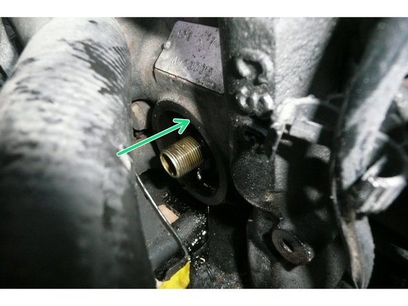 
Place a strap wrench on the cartridge and loosen in the direction shown.
