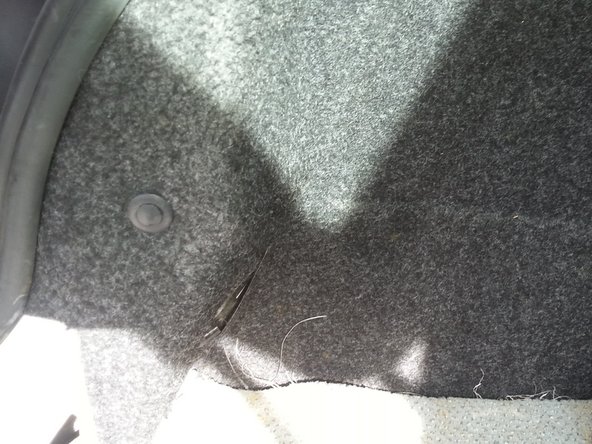 remettre la moquette correctement sous le joint de coffre en caoutchouc puis le clip en plastique.