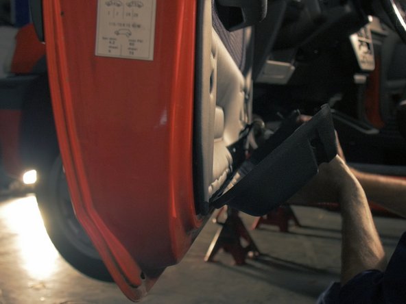 
Be careful to pass the window lifter control connectors through the holes in the storage compartment before removing
