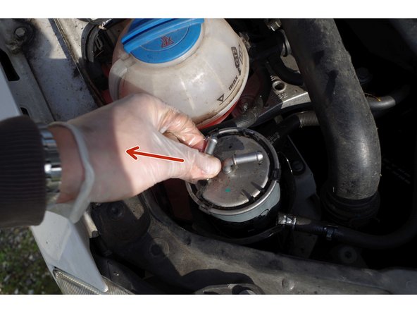 Elle se compose de 3 ergots qui reviennent sur le dessus du filtre. Il suffit des les repousser vers l'extérieur pour qu'on entende un &quot;clic&quot;.