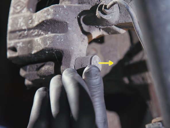 Retirer les deux caches poussière derrière l'étrier de frein