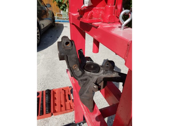 Placez une douille d'extraction de roulement de bonne dimension sur le roulement puis sortez-le à l'aide de la presse.