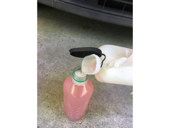 Vider le réservoir dans un récipient pour récupérer le liquide de lave glace en bouchant l'emplacement de la pompe avec le doigt