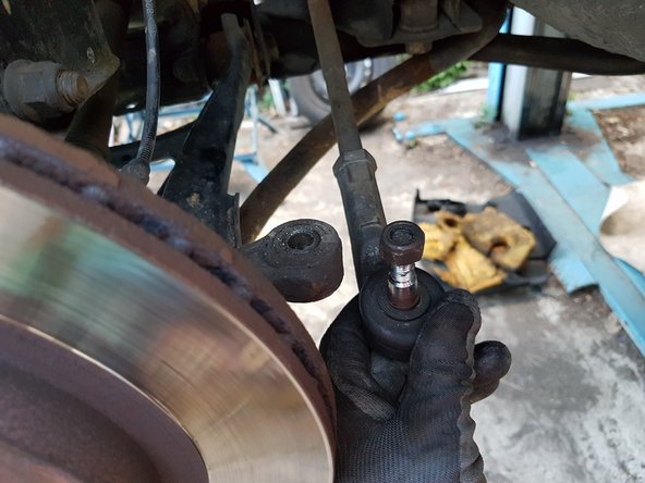 Une fois la rotule déloger, pour pouvoir dévisser l'écrou complètement, il faut que vous fassiez pression sur la rotule par dessous.