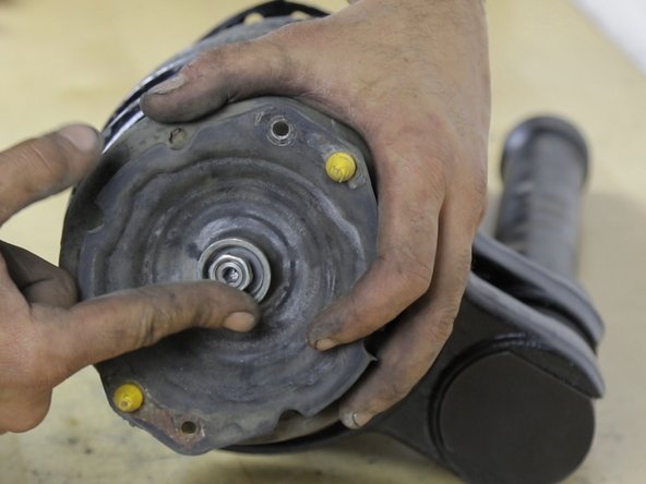 Reposer l'entretoise sur la coupelle et resserrer l'écrou