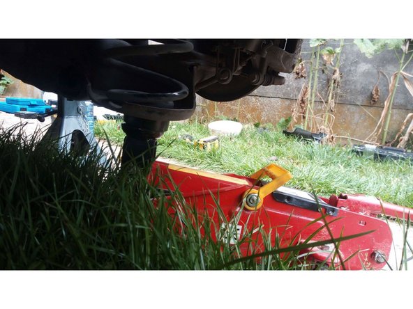 Placer un cric sous le ressort de suspension puis soulager la tension de l'amortisseur en le faisant monter légèrement.