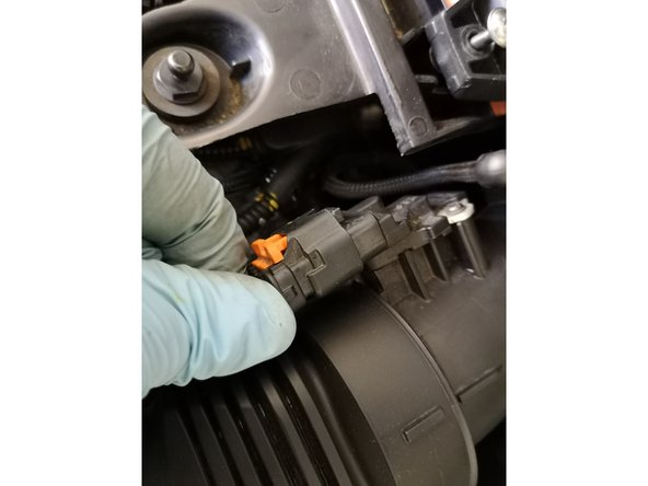 Remettre le second câble en place. Puis pousser sur le loquet orange.