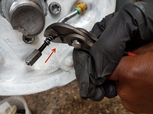 
To undo the handbrake cable, use the multigrip pliers to spread the spring about 2 cm.
