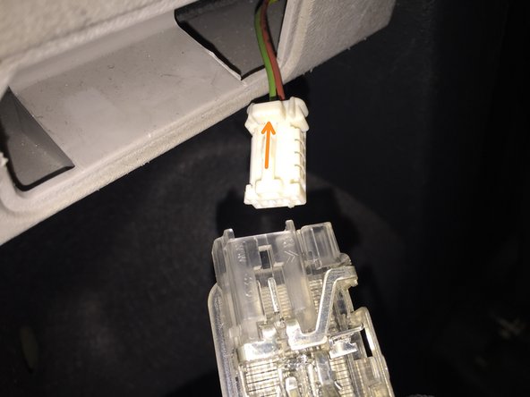 
To remove the electrical connector, press the white tab and pull.
